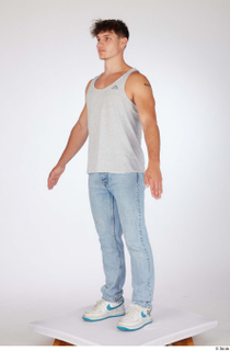 Darren a-poses blue jeans casual dressed grey tank top standing…